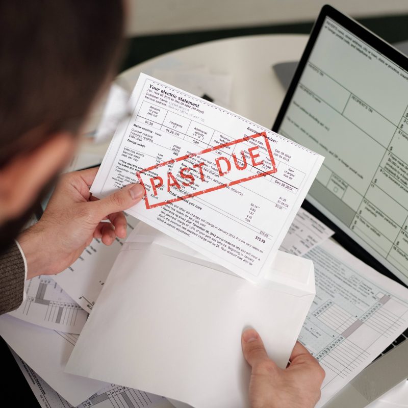 High,Angle,Of,Young,Man,Holding,Envelope,And,Taking,Out